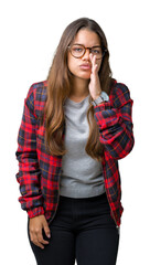 Poster - Young beautiful brunette woman wearing jacket and glasses over isolated background hand on mouth telling secret rumor, whispering malicious talk conversation