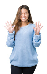 Sticker - Young beautiful brunette woman wearing blue winter sweater over isolated background showing and pointing up with fingers number ten while smiling confident and happy.