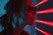 Stylish woman with reflective sunglasses at night, her figure cutting through the red neon lights with a futuristic urban edge.

