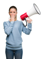 Sticker - Beautiful young woman holding megaphone cover mouth with hand shocked with shame for mistake, expression of fear, scared in silence, secret concept