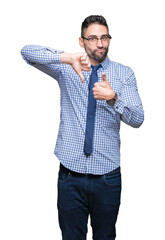 Canvas Print - Young business man wearing glasses over isolated background Doing thumbs up and down, disagreement and agreement expression. Crazy conflict