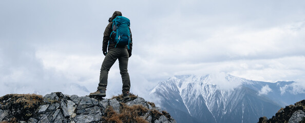 Wall Mural - Woman hiker hiking at mountain top in tibet