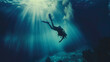 A man is diving underwater with a scuba tank. The water is blue and the sun is shining