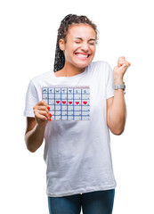 Poster - Young braided hair african american girl holding menstruation calendar over isolated background screaming proud and celebrating victory and success very excited, cheering emotion