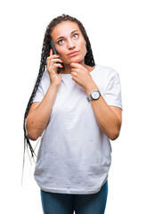 Wall Mural - Young braided hair african american girl showing calling using smartphone over isolated background serious face thinking about question, very confused idea