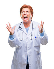 Canvas Print - Senior caucasian doctor woman wearing medical uniform over isolated background crazy and mad shouting and yelling with aggressive expression and arms raised. Frustration concept.