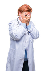 Canvas Print - Senior caucasian doctor woman wearing medical uniform over isolated background with sad expression covering face with hands while crying. Depression concept.