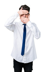 Canvas Print - Young handsome business man wearing glasses over isolated background Covering eyes and mouth with hands, surprised and shocked. Hiding emotion