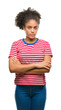© Krakenimages.com - Young afro american woman over isolated background skeptic and nervous, disapproving expression on face with crossed arms. Negative person.