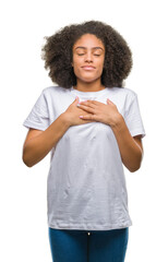 Sticker - Young afro american woman over isolated background smiling with hands on chest with closed eyes and grateful gesture on face. Health concept.