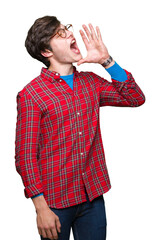 Sticker - Young handsome man wearing glasses over isolated background shouting and screaming loud to side with hand on mouth. Communication concept.