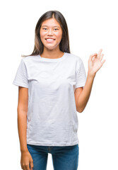 Poster - Young asian woman over isolated background smiling positive doing ok sign with hand and fingers. Successful expression.