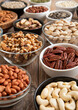 Raw walnuts and cashew with almonds and peanuts with organic nuts and seed in various assorted bowls.Macro