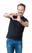© Krakenimages.com - Handsome middle age hoary senior man over isolated background smiling in love showing heart symbol and shape with hands. Romantic concept.