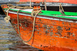Closeup image of a rope pivot for anchor and bird sitting on colorful boat in river Ganges in Varanasi.