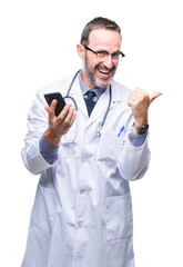 Poster - Middle age senior hoary doctor man texting using smartphone over isolated background pointing and showing with thumb up to the side with happy face smiling