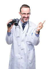 Sticker - Middle age senior hoary doctor man looking through binoculars isolated background very happy pointing with hand and finger to the side