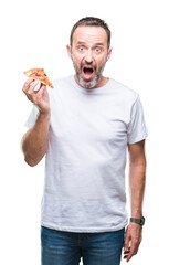 Wall Mural - Middle age hoary senior man eating pizza slice over isolated background scared in shock with a surprise face, afraid and excited with fear expression
