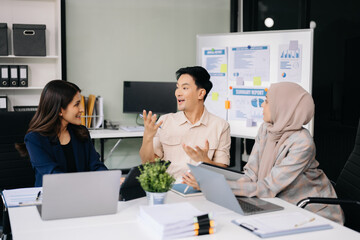 Group of young business people discussing business plan at modern startup in creative business discussing work modern office building.