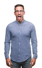 Poster - Handsome young elegant man wearing glasses sticking tongue out happy with funny expression. Emotion concept.