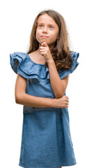 Poster - Brunette hispanic girl wearing denim dress serious face thinking about question, very confused idea