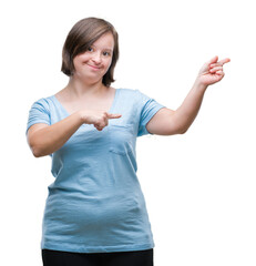 Wall Mural - Young adult woman with down syndrome over isolated background smiling and looking at the camera pointing with two hands and fingers to the side.