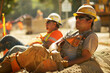 Relaxed construction worker on break, reflecting on Labour Day amidst a busy work site