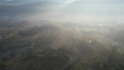 Wall Mural - Aerial view from drone of the rural village in the mountains on foggy day