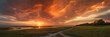 3:1 banner. phenomenon of fiery clouds during sunset. The colors and textures of the fiery clouds with the rays of the setting sun, creating a magnificent scene that highlights the beauty of nature.