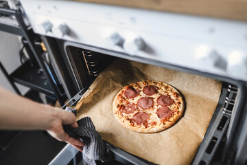 Wall Mural - Girl cooking pizza at home