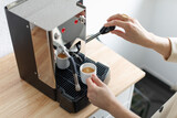Fototapeta Mapy - Cooking coffee at home with home coffee machine