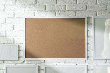 Poster - Varied Sized Photo Frames Displayed on a White Brick Wall