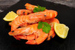 Group of freshly cooked shell on crevettes with lemon and parsley herb garnish