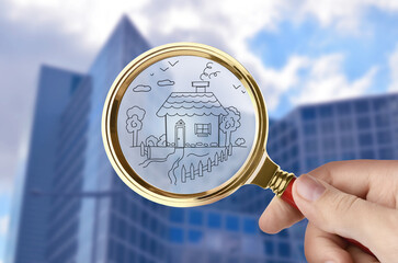 Wall Mural - Woman holding magnifying glass with drawing of house against building, closeup. Search for apartment