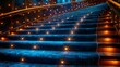 Stairs with a blue carpet and lights, stairs leading to the stage of an opera house. A staircase covered in a dark blue fabric decorated with glowing stars on each step creates a luxurious atmosphere 