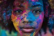 Close-up face shot of Afro American black young woman covered in Holi Powder. Holi color fest celebrating in India