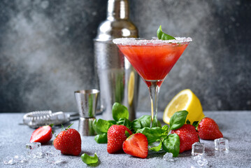 Wall Mural - Cold summer strawberry cocktail with lemon and basil in a  martini  glasses .