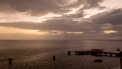 Wall Mural - 4k timelapse of the sun setting over the docks in Roseau, Dominica