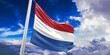 Netherlands national flag cloth fabric waving on beautiful Blue Sky Background.