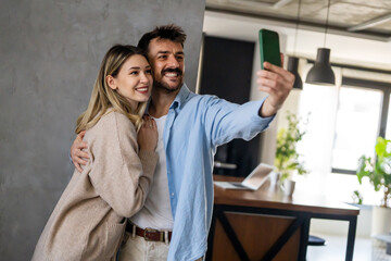 Canvas Print - Capturing happy moments together. Happy young loving couple making selfie and smiling.