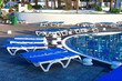 Terrace with sun loungers by the pool. Comfortable loungers beside the tranquil pool