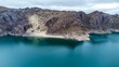 Landscape of a dam on Embalse Valle Grande in Argentina with rocky mountains by turquoise water