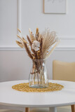 Fototapeta  - Kwiatek w wazonie na stole
