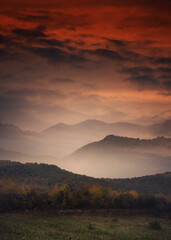 Wall Mural - sunset sky and mountains in fog, fantasy landscape