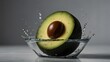 half-sliced avocado with its seed intact, set against a dark background. The avocado is captured mid-splash, with water droplets suspended around it, creating a dynamic and fresh appearance