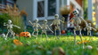 Skeleton figurines dancing at green yard outside of a house. Cute decorative funny playful figures at the sunny backyard