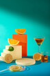 Some lemon displayed on a blue background with orange rectangular and some lemon slices. Blank space for product brand presentation and advertising cosmetic from lemon ingredient
