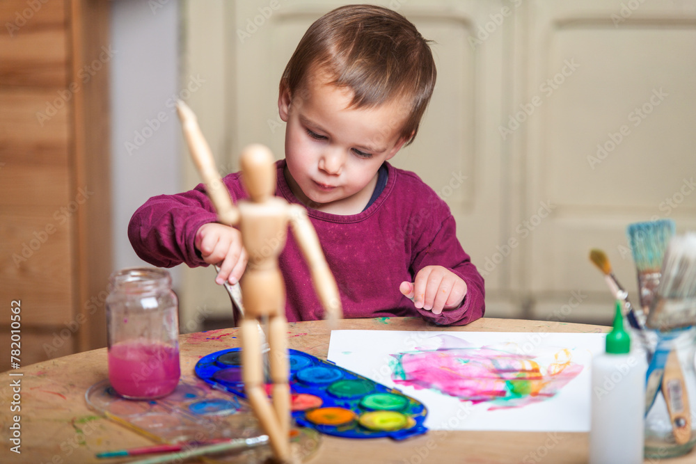 Young boy doing his creative activity of painting with watercolors at ...