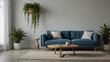 A blue couch sits in the center of a room with two potted plants on either side of it.

