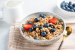 Multigrain porridge bowl with blueberries, strawberries for healthy vegan breakfast. Clean eating concept. Closeup view